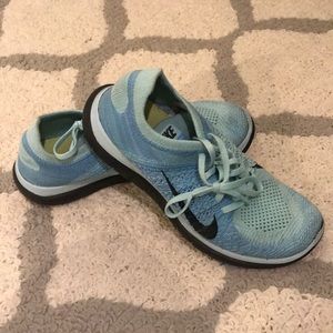 Nike blue and black fly knit running shoes.